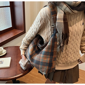 Detail of a large plaid tote bag in wool-like fabric with autumn lifestyle aesthetic