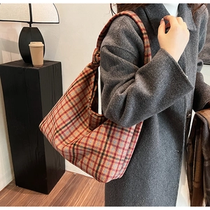 Detailed view of a vintage plaid hobo shoulder bag with a stylish knotted strap design