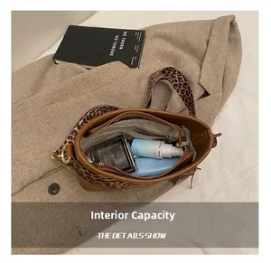 Interior view showing the large capacity and leopard print strap of the crossbody bucket bag