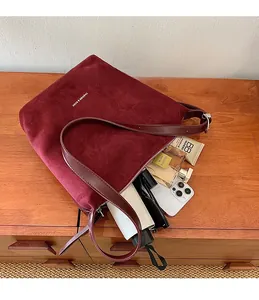 Top view of spacious interior of a burgundy faux suede tote bag showing large capacity