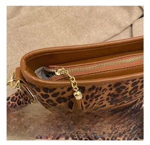 Detail show of leopard print bucket bag featuring premium gold hardware and zipper