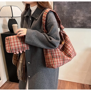 Detail of the vintage plaid wool fabric and stylish knotted strap on this tote bag