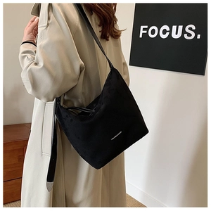 Close-up of a black PU leather tote bag with Fashion & Bags text on a model