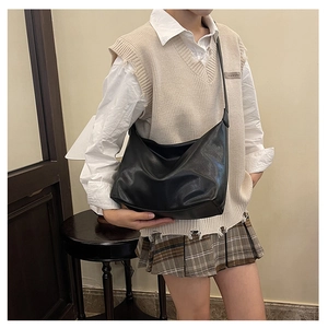 Large black hobo shoulder bag with matte finish shown on a model for casual styling