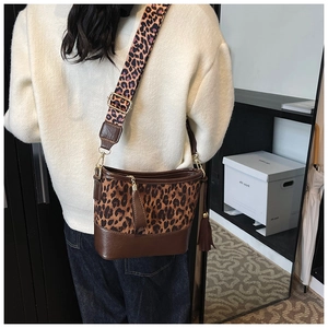 Detail of leopard print bucket bag with leather tassels and wide shoulder strap