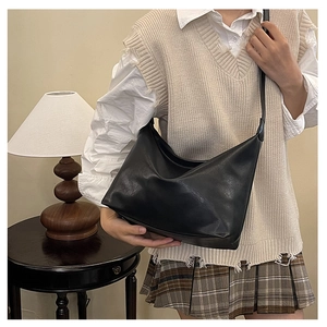 Lifestyle shot of black large crescent moon crossbody bag with adjustable strap