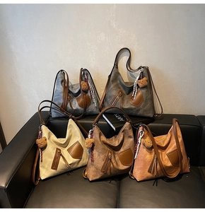 Detailed arrangement of multi-colored retro tote bags with leather trim and bear charms