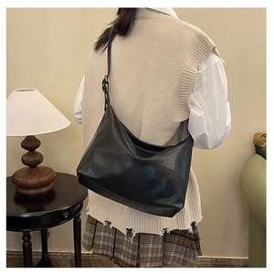 Retro black leather large capacity hobo bag styled with a vintage aesthetic outfit