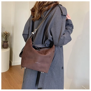 Detail of dark brown matte hobo bag with adjustable strap and metal bottom studs