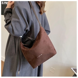 Detail of dark brown frosted leather shoulder bag with Fashion & Bags text on hobo design