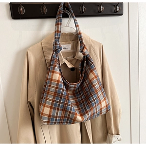 Detail of the blue and orange plaid tweed hobo bag with unique knotted shoulder strap