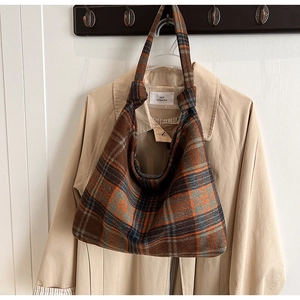 Detail of the autumn plaid wool tote bag with a unique knot shoulder strap decoration