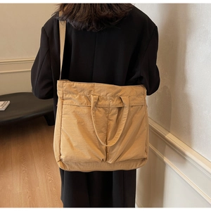 Detailed view of khaki nylon tote bag showing soft texture and large capacity fit
