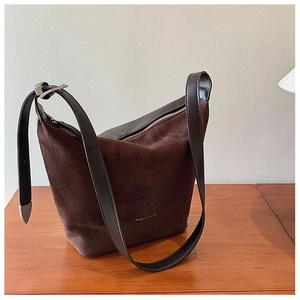 Macro view of vintage brown matte leather shoulder bag with embossed fashion logo and silver buckle