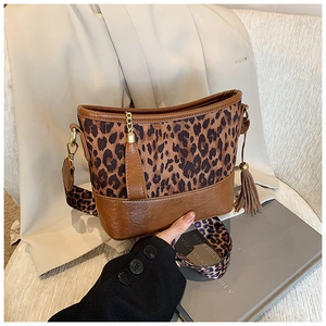 Close-up of leopard print stitching and brown lychee leather with side tassel detail