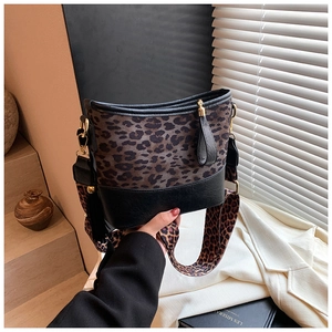 Detailed shot of leopard print bucket bag with gold hardware and tassel zipper details