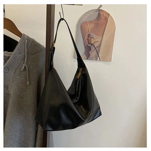 Detail of black matte leather hobo bag with adjustable buckle strap and gold zipper