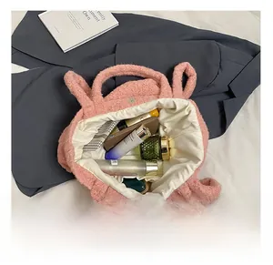 Detailed interior of pink plush tote bag showing large capacity for cosmetics