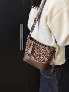 Retro leopard print hobo bucket bag with wide shoulder strap and leather fringe tassel