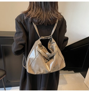Detail of khaki glossy synthetic leather backpack with liquid metal texture and slim straps