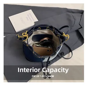 Internal capacity of denim bucket bag showing zip pocket for daily essentials