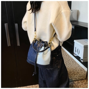 Detailed view of a vintage patchwork bucket bag with denim fabric and drawstring closure