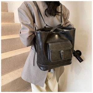 Detail of vintage black tote bag with white contrast stitching and buckle pocket