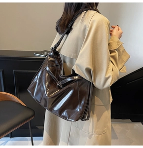 Deep brown oversized hobo tote with white contrast stitching and shiny leather texture