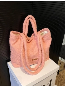 Pink plush tote bag with shoulder straps and our fave label in a versatile casual style