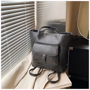 Detail of retro oil-waxed PU leather tote with front flap pocket and decorative buckle