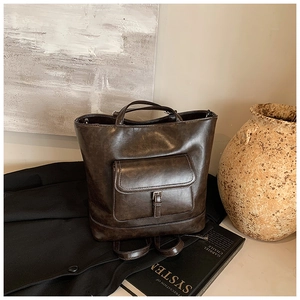 Detail of vintage oil wax leather tote bag with functional metal buckle front pocket