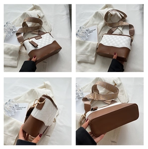 Detail of woven texture and brown leather base on a versatile crossbody bucket bag