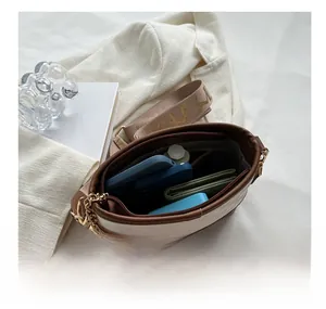 Interior view of beige crossbody bucket bag showing large capacity for essentials