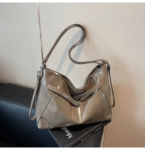 Macro view showing spacious interior and glossy oily leather texture of the brown tote bag