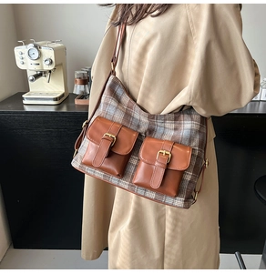 Detail of vintage brown plaid wool shoulder bag with dual leather front pockets