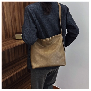 Back view of a khaki brown hobo bucket bag showing large capacity and soft leather texture