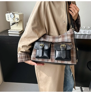 Detailed view of the retro plaid pattern and leather pocket buckles on the shoulder bag