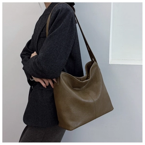Close-up of olive green oversized hobo bag with vintage crinkled leather texture