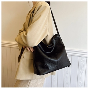 Close-up of a large black hobo shoulder bag featuring soft textured leather for daily commute