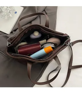 Spacious interior of retro brown leather tote bag with zip pocket and daily essentials