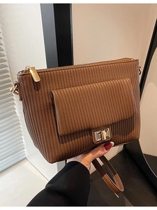 Brown ribbed shoulder bag with gold twist lock and adjustable strap for women