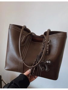 Large brown leather tote bag with white contrast stitching and cat charm for women