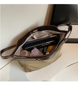 Top view of spacious canvas tote bag interior showing books, tablet and daily essentials