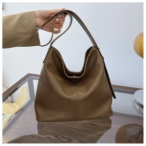 Detailed texture of the dark brown wrinkled leather on this large minimalist Hobo bag