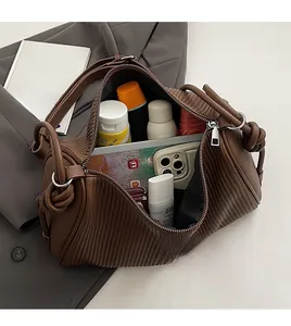 Top view showing the spacious interior of a brown pleated crescent tote bag with essentials