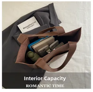 Deep brown tote bag showing spacious interior with tablet, umbrella, and notebooks