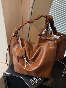 Brown leather tote bag with pleated scrunchie strap and cute teddy bear charm