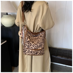 Lifestyle view of a vintage leopard print bucket bag with brown leather straps