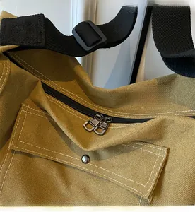 Detail of premium heavy canvas messenger bag featuring a smooth two-way metal zipper