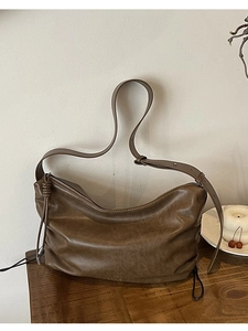 Retro dark brown leather hobo shoulder bag with pleated texture and side tassels